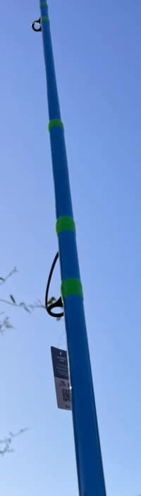 Over the Bar 13' Blue fishing rod with green wraps and grips